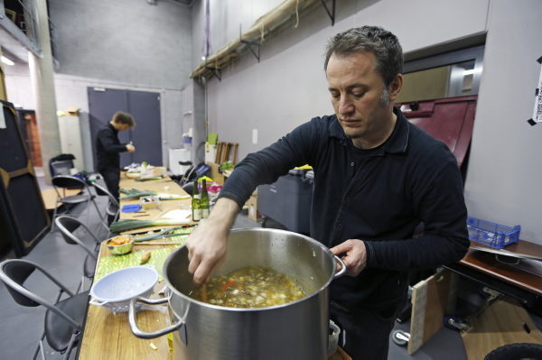 Austrian musician Jurgen Berlakovich, who is a member of the Vegetable Orchestra, cooks a soup from vegetables leftover from making musical instruments during the preparations for a concert in Haguenau, eastern France
