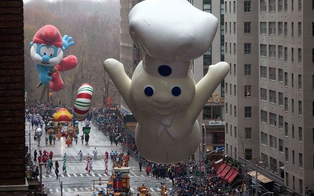 The Pillsbury Doughboy float makes its way down 6th Ave during the Macy's Thanksgiving Day Parade in New York